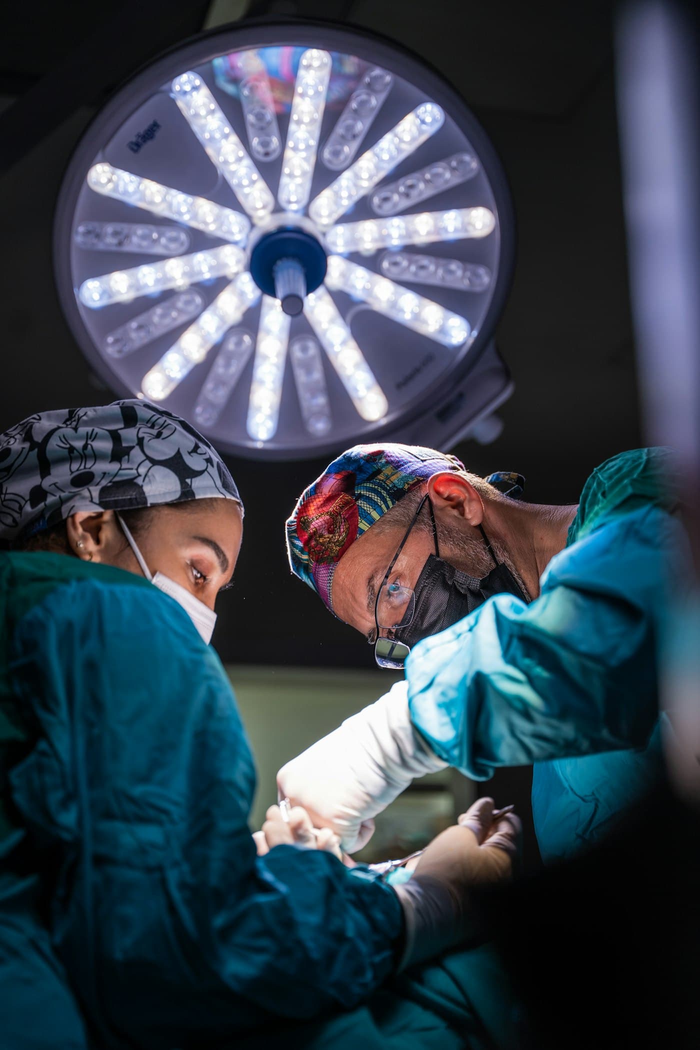 Two surgeons at work under operating-room lights